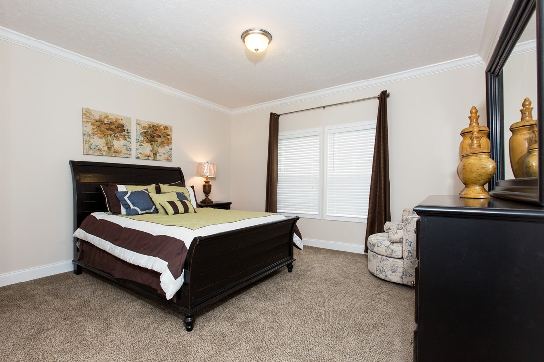 The J533 MOD Primary Bedroom. This Manufactured Mobile Home features 3 bedrooms and 2 baths.